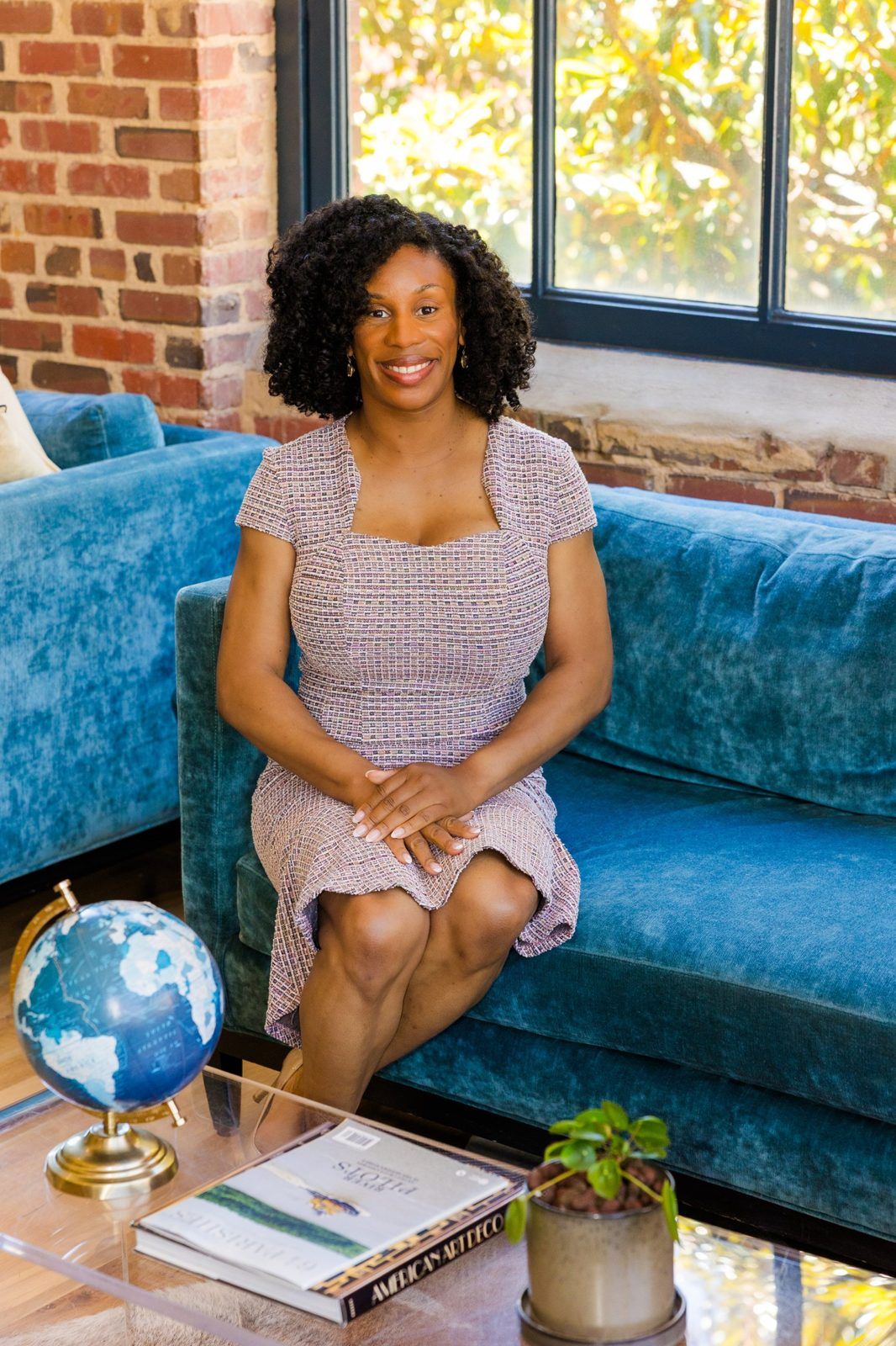 Cassandra Davis, founder of CDavis Enterprises, seated in a sunlit office